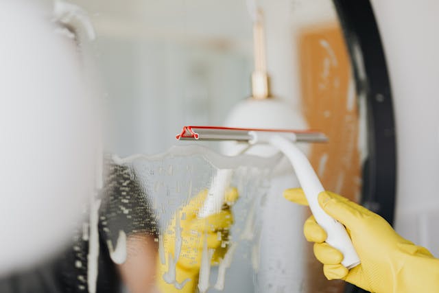 hands cleaning glass